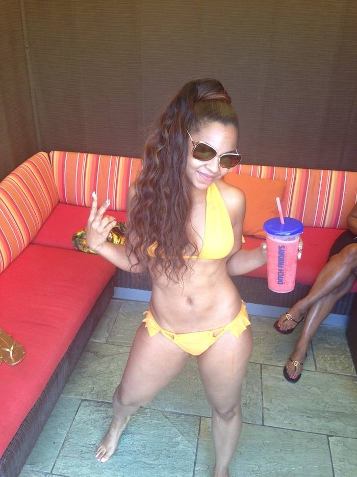 Ashanti sips on a virgin strawberry daiquiris while relaxing in a cabana at the Palms Pool. 