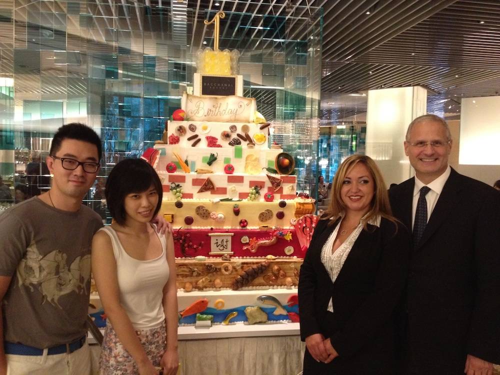 Yao Cheng, One-Millionth Guest Tianshu Sun, General Manager of Bacchanal Gabrielle Perez and President of Caesars Palace Gary Selesner in front of Bacchanal birthday cake at Bacchanal Buffet at Caesars Palace. 