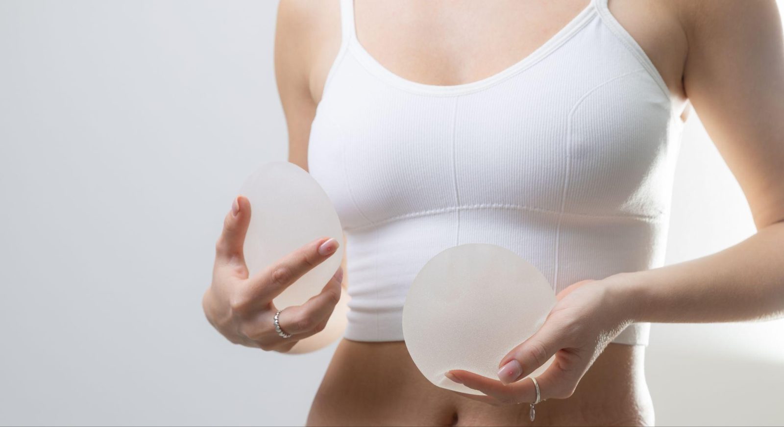 women-holding-breast implants